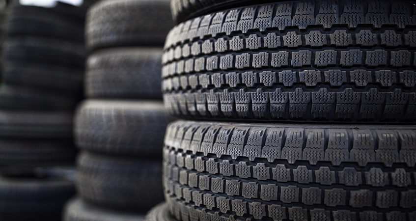 Mechanic selecting a tyre from a rack